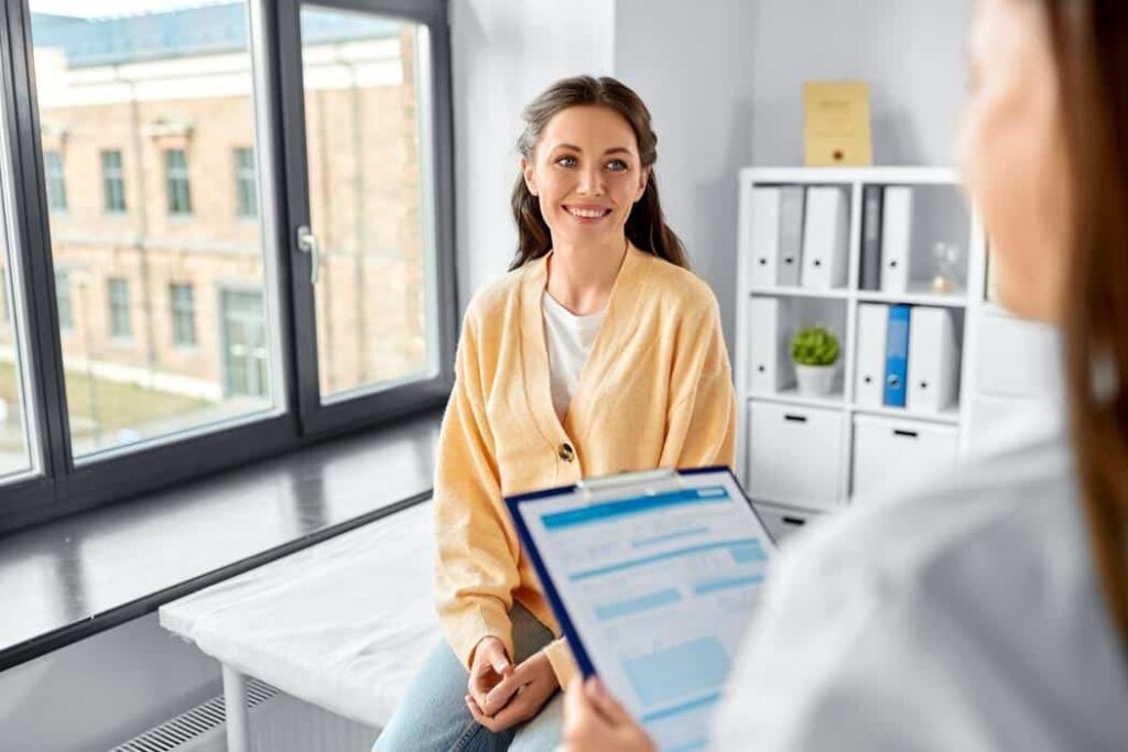 patient-doctor-paperwork-smiling-care Surgery Center Forms